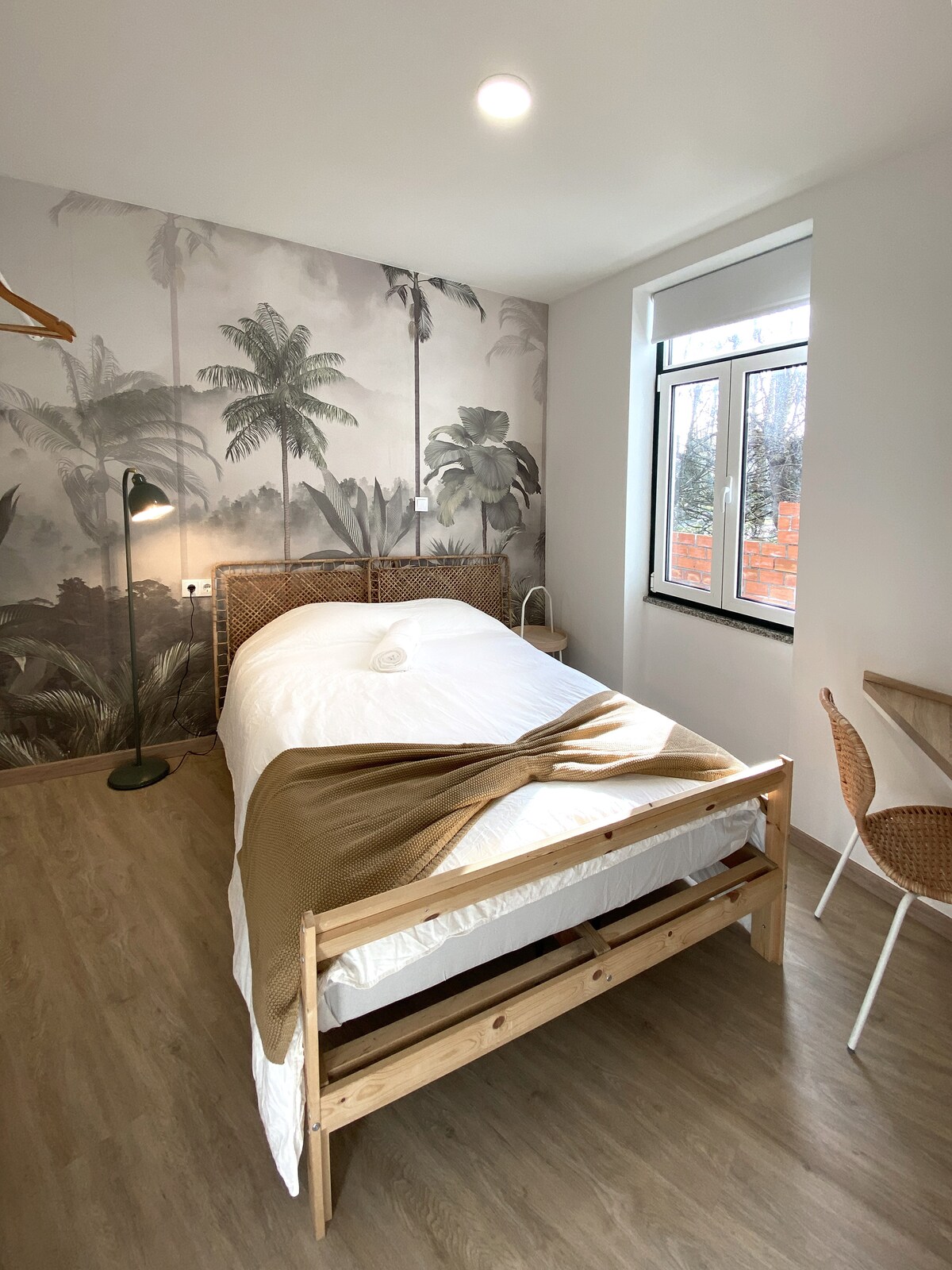 Wood frame bed with palm mural